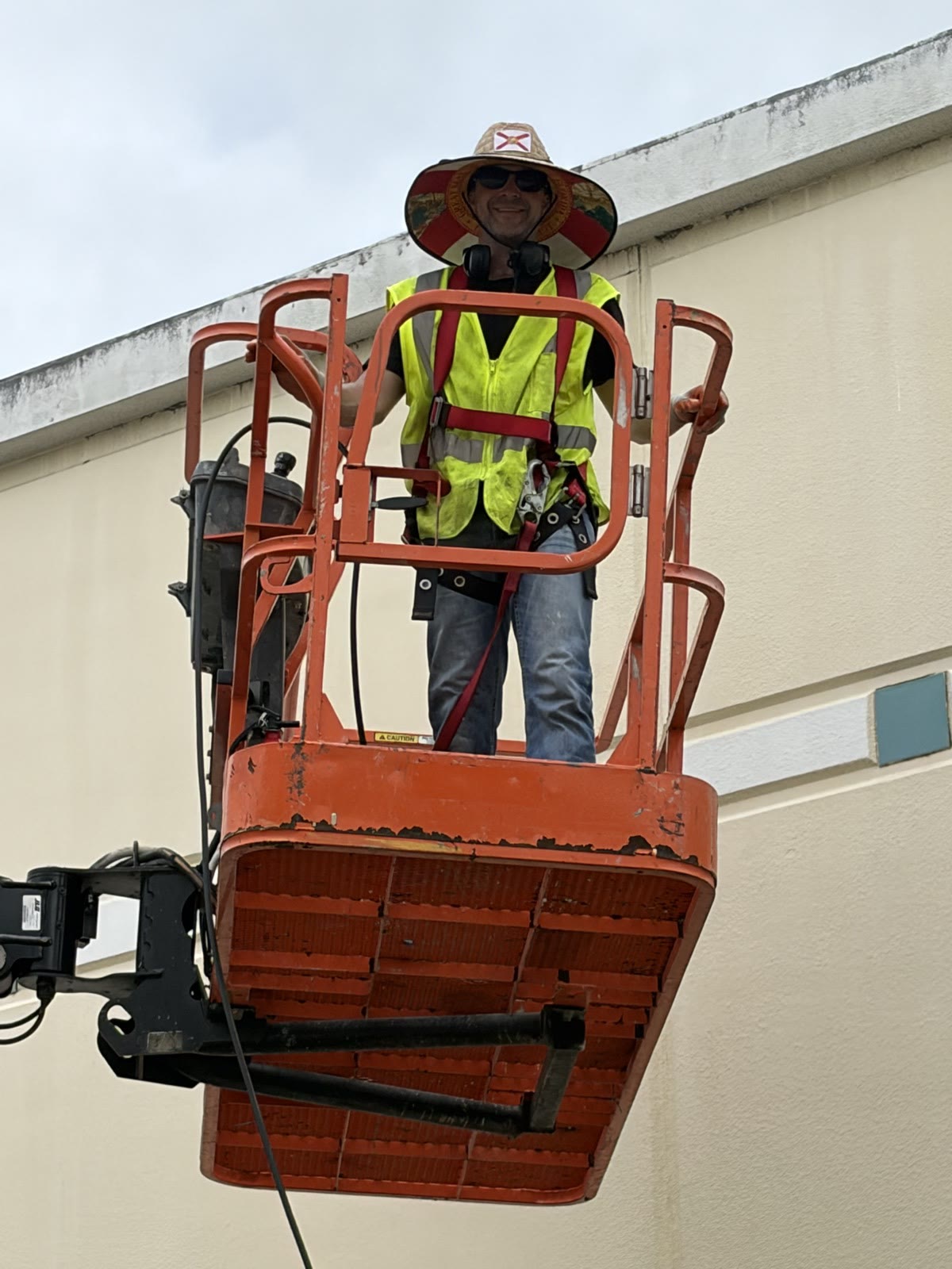 Worker in a boom lift at a commercial facade