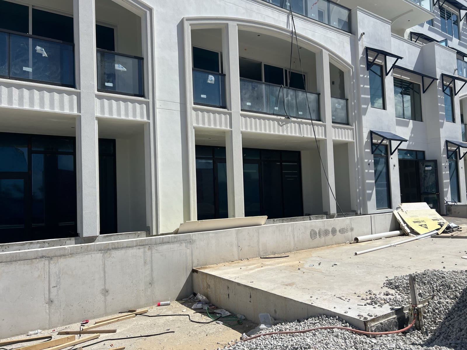 Mixed-use building under construction with site work in progress